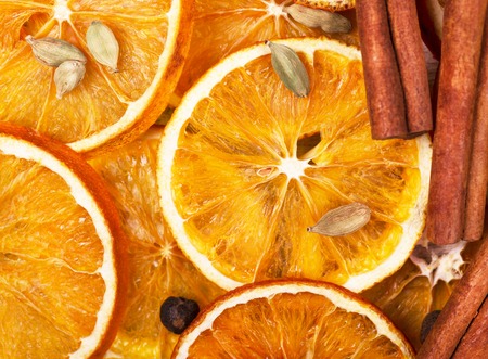 Dry slices of orange, cinnamon, allspice and cardamom. Close-up