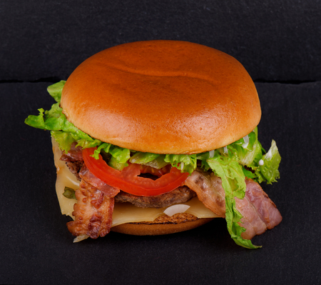 Fresh tasty burger, on black stone backgroundの写真素材