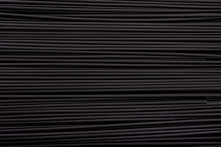Black pasta background. Black spaghetti with squid ink, background. Pasta with black cuttlefish ink.の写真素材