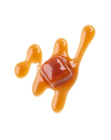 Sweet caramel candies and sauce, isolated on white background. Delicious caramel. Top viewの写真素材