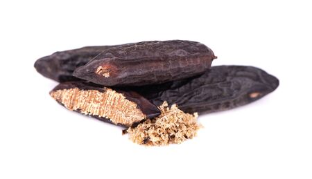 Tonka beans isolated on white background. Bean of Dipteryx odorata, cumaru or kumaru. Fresh aroma tonka bean powder. Close-upの写真素材