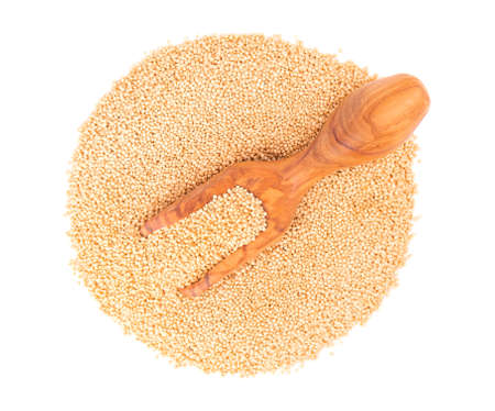 Amaranth seeds in wooden scoop, isolated on white background. Organic dry raw amaranth beans. Top viewの写真素材