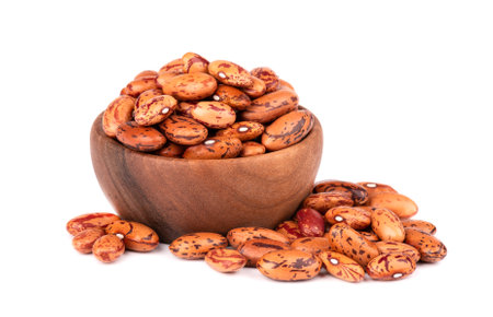 Beans in wooden bowl, isolated on white background.