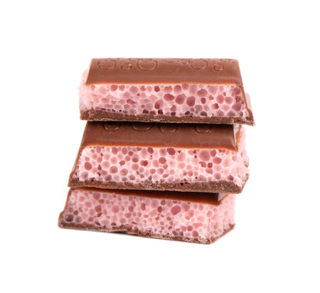 Porous chocolate pieces isolated on white background. Pink strawberry aerated chocolate