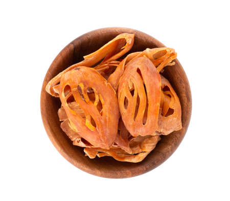 Mace in a wooden bowl, isolated on white background. Nutmeg flower, myristica fragrant. Natural...