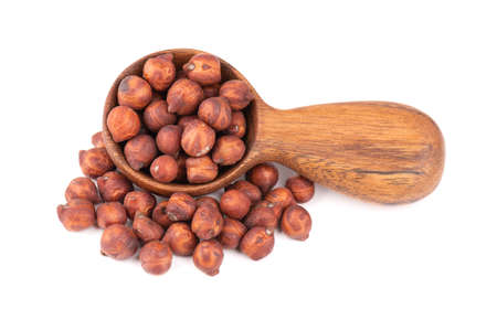 Pile of brown chickpeas in wooden spoon, isolated on white background. Brown chickpea. Garbanzo, bengal gram or chick pea bean.の写真素材