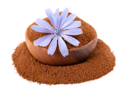 Chicory powder and flower in wooden bowl, isolated on white background. Cichorium intybus.の写真素材
