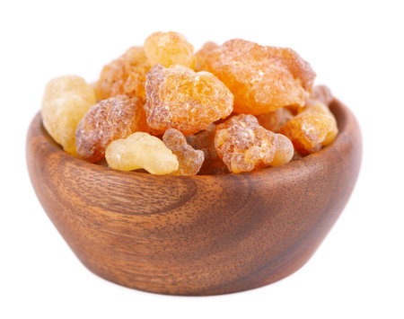 Frankincense resin in wooden bowl, isolated on white background. Pile of natural frankincense Olibanum. Incenseの写真素材