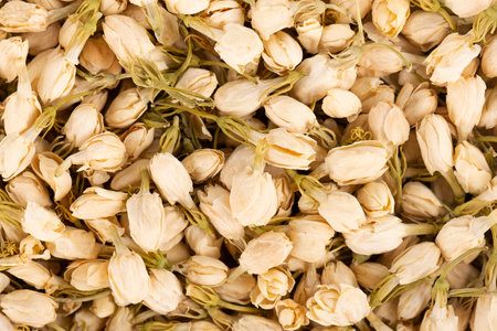 Dry jasmine flowers background. Jasmine flowers tea. Herbal tea. Top view.
