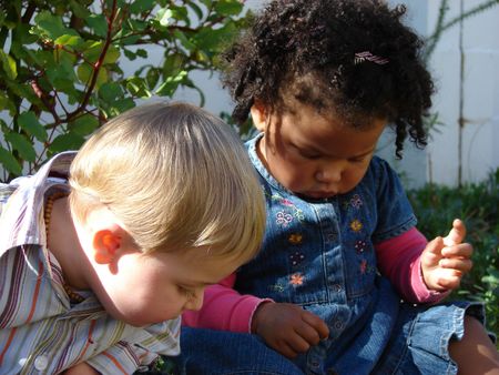 Little girl and boy playing outsideの写真素材