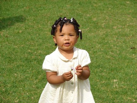  girl eating chocolate outsideの写真素材