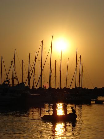 Boats in the harbour as the sun is settingの写真素材