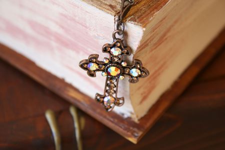 Close up of cross in the form of Jewellery on a wooden Jewellery boxの写真素材