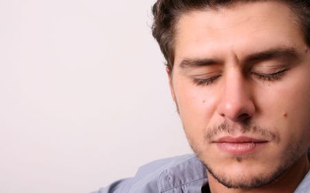 Male model in studio against white wall