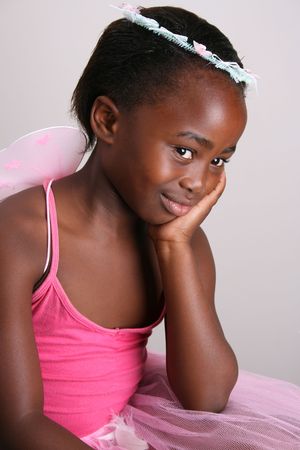 Young girl wearing a pink fairy costume with accessoriesの写真素材