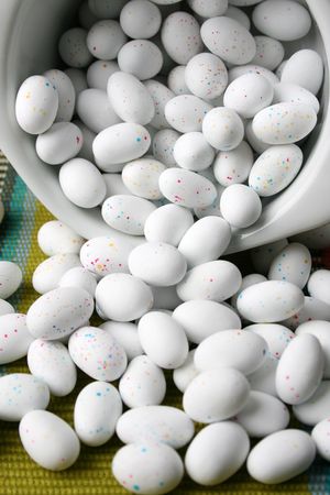 Miniature speckled easter eggs in a green bowl
