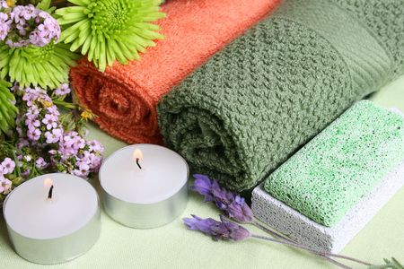 Spa Accessories setting with face cloths, candles and flowersの写真素材