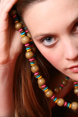 Beautiful female model with blue eyes and a string beadsの写真素材