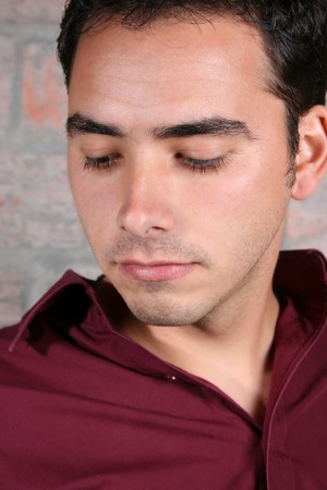 Male model against a rough brick wall backgroundの写真素材