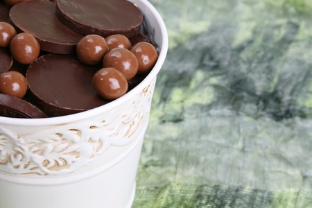 Variety of chocolates in a small white bucketの写真素材