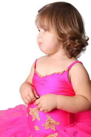 Little girl with short hair wearing a bright pink ballet outfitの写真素材