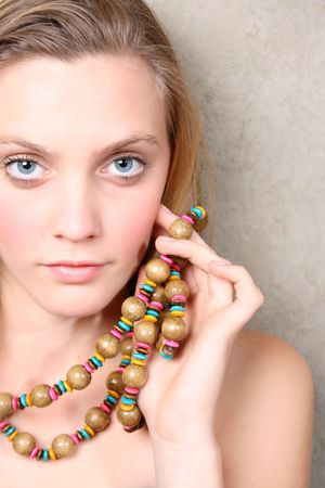 Beautiful female model with blue eyes and a string beadsの写真素材