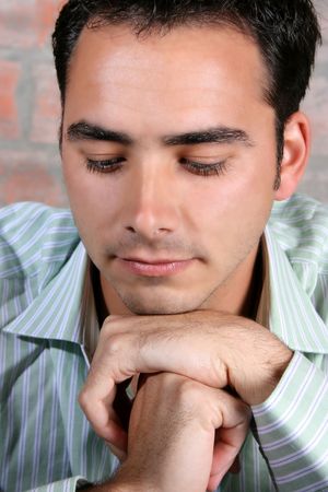 Male model against a rough brick wall backgroundの写真素材