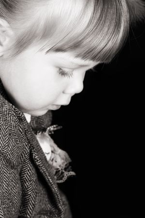 Portrait of a little girl with red hair on dark backgroundの写真素材