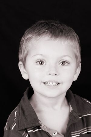 Beautiful blond toddler against a black background