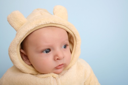 Two month old baby boy wearing a soft animal suitの写真素材
