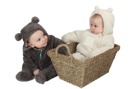 Two babies dressed in furry teddy bear suitsの写真素材