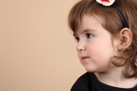Cute little brunette toddler with serious expression の写真素材