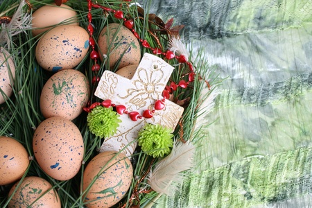 Easter wreath with eggs and decorations on green cloth