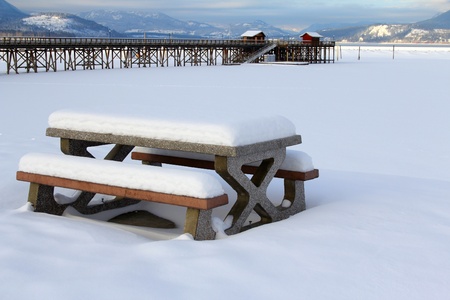 Snow covered picnic bench at Salmon Arm Pier, BC, CANADAの写真素材