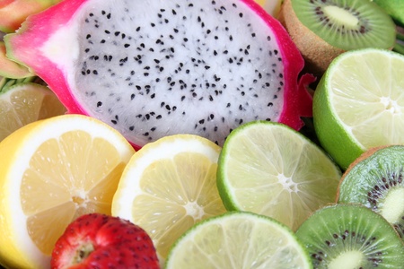 Variety of colorful sliced fruits on a basketの写真素材