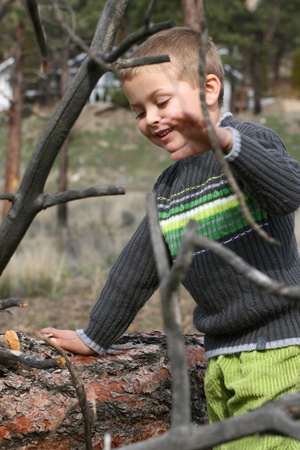 Little blond boy playing outside in the fieldの写真素材
