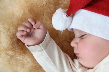 Baby boy wearing a christmas hat sleeping soundの写真素材