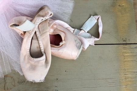 Worn pointe shoes on a pink net tutuの写真素材