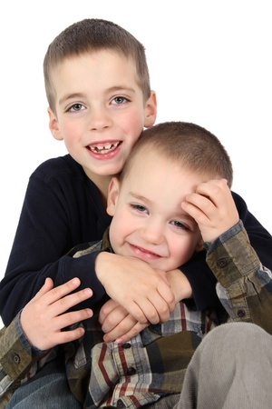 Two young brothers against a white background の写真素材
