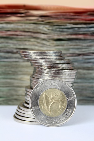Stack of coins in front of stack of notes, Canadianの写真素材
