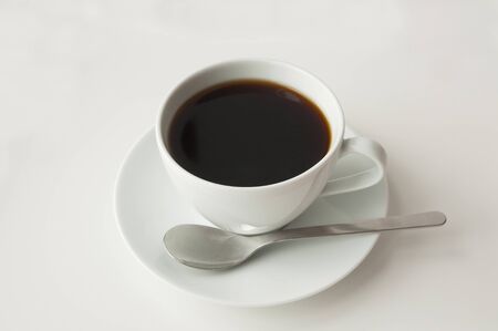 a white cup of coffee with white backgroundの写真素材