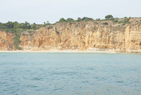 seascape with rocky cliffs in the lagos in southern portugalの写真素材