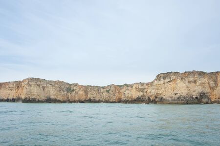 seascape with rocky cliffs in the lagos in southern portugalの写真素材