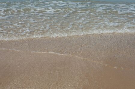 relaxing beach scene with waves and sandの写真素材