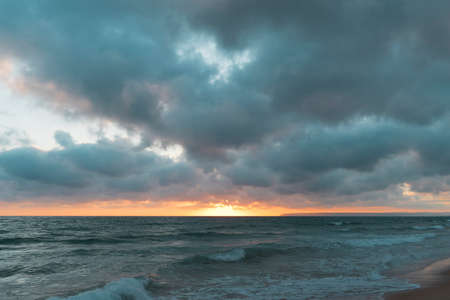 nice cloudy sunset on the sea forming a stormの写真素材