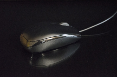 Computer mouse on a dark background closeupの写真素材