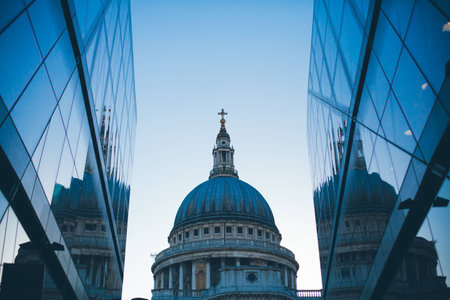 St Paul's church and its reflections on the building windows across the street.の写真素材
