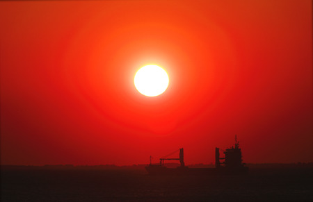 Cargo ship at sunsetの写真素材