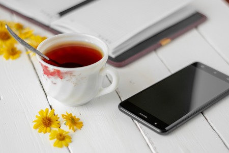 A Cup of tea and a Notepad with pen