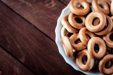 bagels are in a white plate, which stands on a wooden tableの写真素材